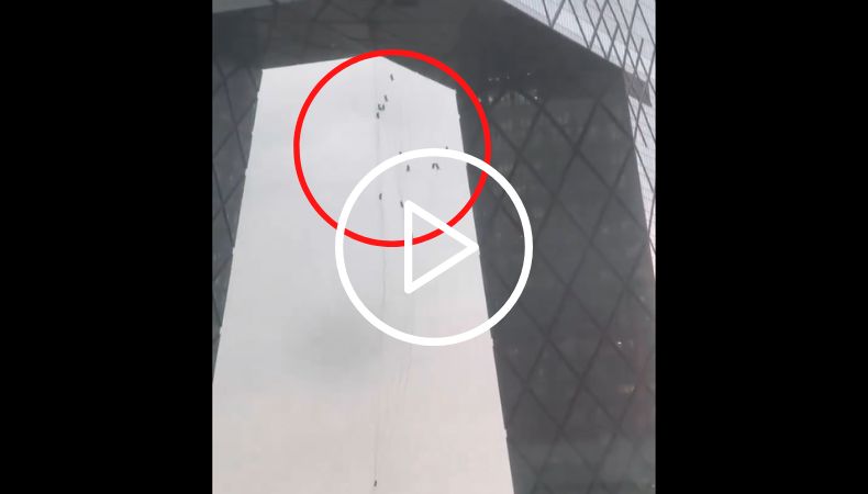 Trabajadores colgados de un edificio en China