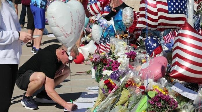 Ciudadanos rinden homenaje a Charlie Kirk en un monumento improvisado frente a la sede de Turning Point USA en Phoenix, tras su asesinato en Utah.