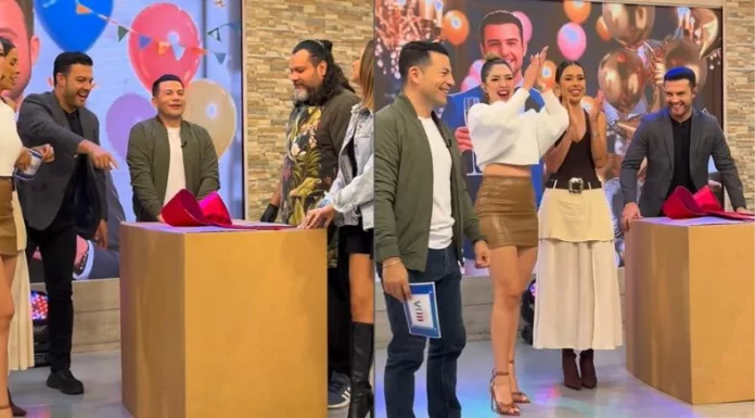 Un enorme paquete con moño rojo y dos invitados inesperados saliendo de una caja de regalo durante la despedida de soltero que el equipo de “Viva la Mañana” le preparó a Carlos Iraheta.